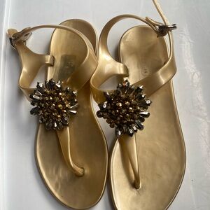 Gold plastic coach, sandals with sunflower